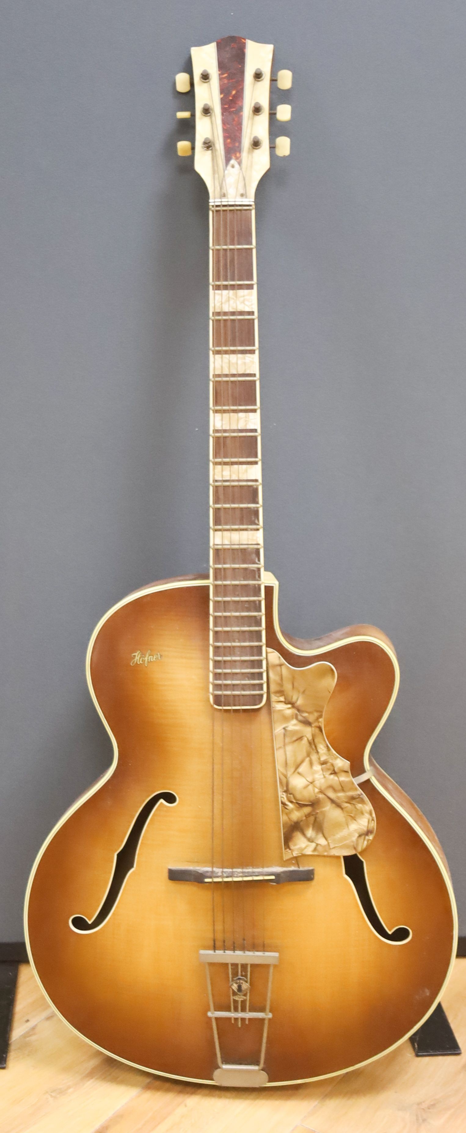A Hofner acoustic f-hole guitar, circa 1950, having mother of pearl and tortoiseshell inlay to fret and head